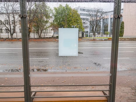 White sheet of paper on wet glass from the rain. Place for text.