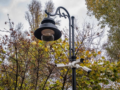 Outdoor surveillance cameras on a street lighting pole. Security. Place for text.