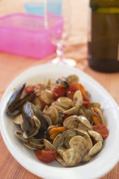 sautè of clams and mussels in a serving dish.