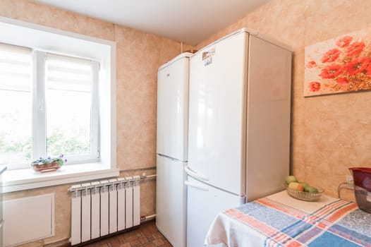 Russia, Moscow- July 01, 2019: interior room apartment. standard repair decoration in hostel. modern kitchen, dining area