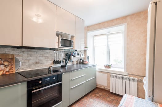 Russia, Moscow- July 01, 2019: interior room apartment. standard repair decoration in hostel. modern kitchen, dining area