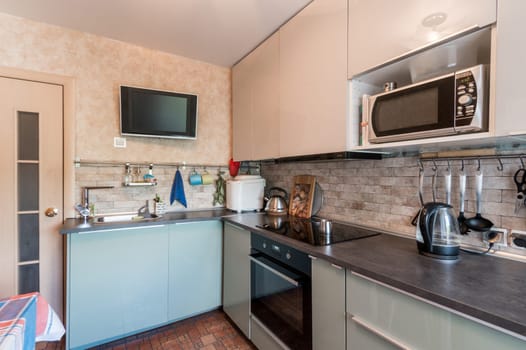 Russia, Moscow- July 01, 2019: interior room apartment. standard repair decoration in hostel. modern kitchen, dining area