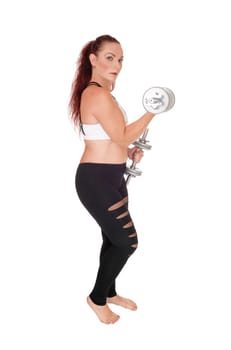 An exercising woman standing in workout outfits and lifting.up the two dumbbells in her hand, isolated for white background.