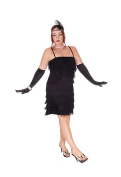 A gorgeous woman in a black dress of the 20 century and long cloves.dancing in the studio, isolated for white background.