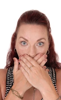 A beautiful woman with long red hair holding her hands over her mouth,. I should not have sad this, isolated for white background.