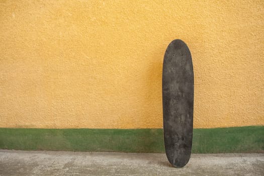 Skateboard on a wall. Used skateboard.
