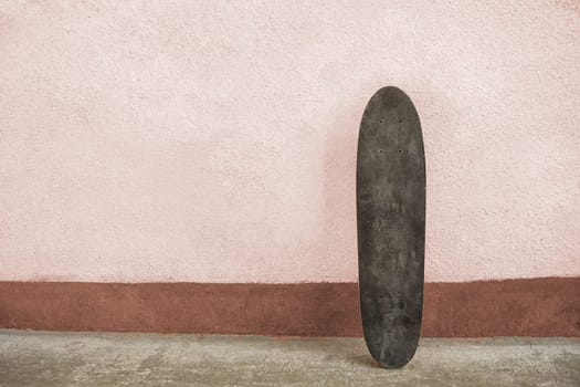 Skateboard on a wall. Used skateboard.
