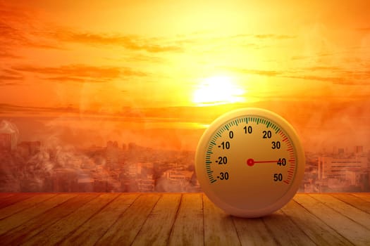 The thermometer on a wooden table with a high temperature on the city with a glowing sun background. Heatwave concept