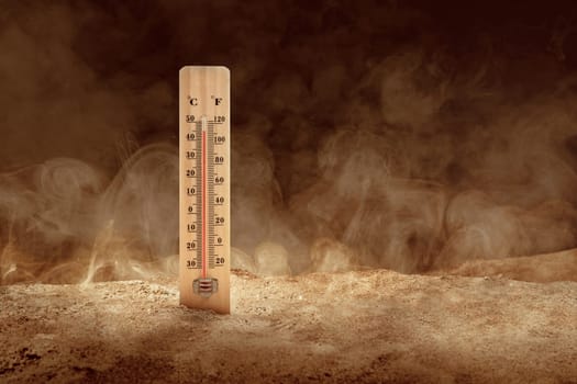 Thermometer with high temperature on the desert with a dusty background. Heatwave concept
