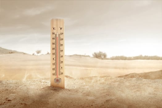Thermometer with high temperature on the desert with sunlight background. Heatwave concept