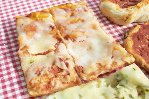 pizza by the slice called crostino with ham and mozzarella cheese