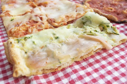 pizza by the slice called crostino with ham and mozzarella cheese