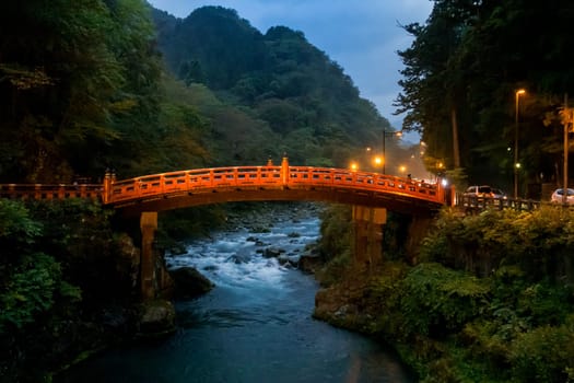 Landmark Red bridge over river creek in Nikko Tochigi Japan at twilight dusk sunset.