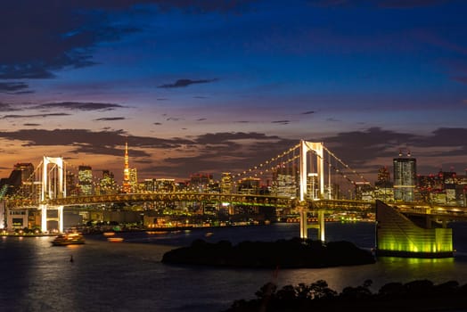 Aerial view of Tokyo skylines with Rainbow bridge and tokyo tower over Tokyo bay Sunset Twilight from Odaiba in Tokyo city Kanto Japan.
