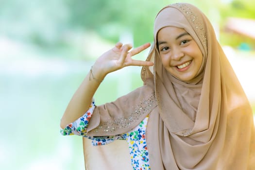 Portrait of good-looking Happy young teenager Muslim islamic asian university girl