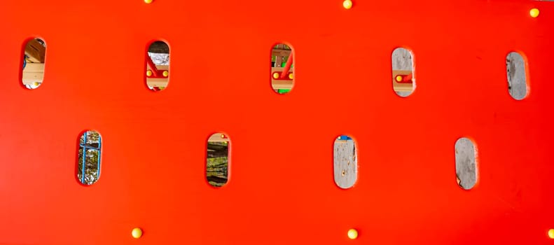 Red plastic background with holes. Place for text.