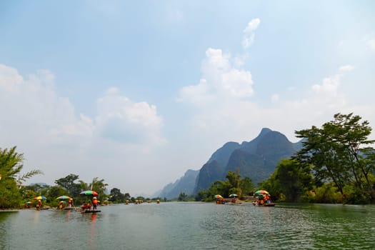 Bamboo rafts on Yulong (Dragon) River on rainy day. China. Yulong River Rafting is main tourist activity in Yangshuo area