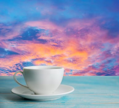 A cup of coffee with abstract sky and cloud sky and color of sunset or sunrise in twilight, Relax concept