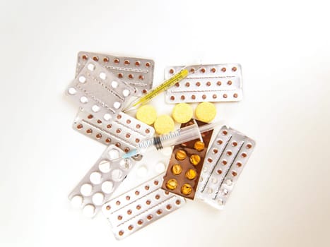 Medical syringe and thermometer on tablets. Place for text. Medicine and health. Injection
