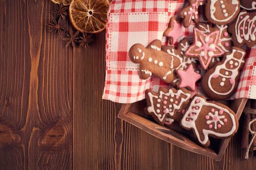 Christmas gingerbreads. Handmade cookies on tray lying on the wooden background with copy space for text. Top view. Christmas and New Year treats.