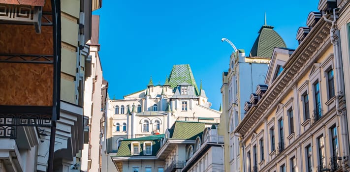 Roofs of old urban houses on a background of blue sky. City landscape