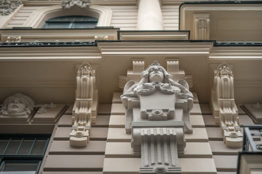 Bust of a girl on the facade of a historic building in Riga, Latvia, bottom view