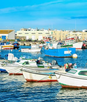 Peniche harbor, fishing boats in row, docks in background, Portugal