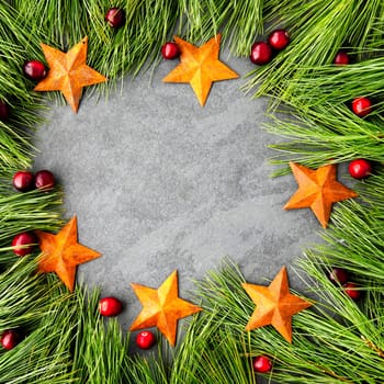 Pine boughs, stars and cranberries rustic Christmas themed frame with slate copy space area. Great for social media.