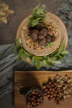 Delicious naked coffee and hazelnuts cake on table rustic wood kitchen countertop.