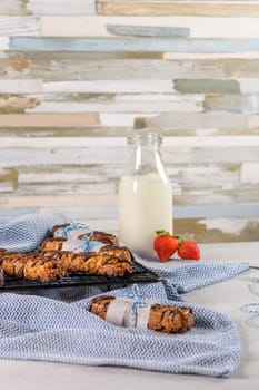 Cereal bars with peanuts and chocolate on kitchen counter top.