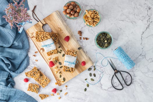 Organic homemade granola bars on rustic marble stone kitchen countertop.