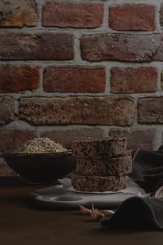 Raw veggie burger with black beans with on wood countertop.