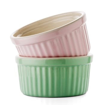 Two colored bowls on white reflective background