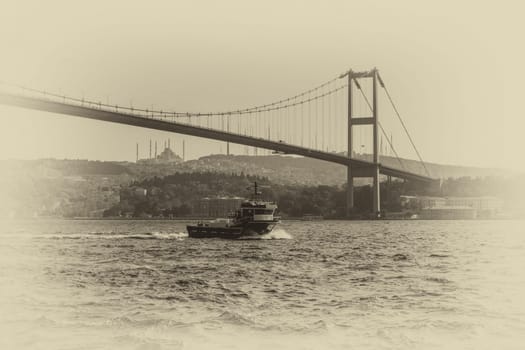 Bosphorus Bridge and a cargo ship, retro style photo, Istanbul.