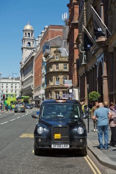 LIVERPOOL, ENGLAND, UK - JUNE 07, 2017: Britsh vintage taxi cab on the streets of Liverpool.