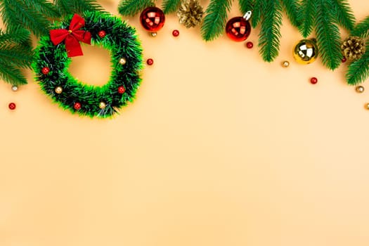 Christmas holidays composition, top view of red and gold Christmas decorations on yellow background with copy space for text. Flat lay, winter, postcard template, new year concept.