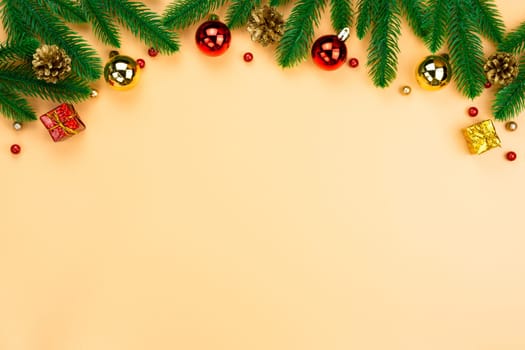 Christmas holidays composition, top view of red and gold Christmas decorations on yellow background with copy space for text. Flat lay, winter, postcard template, new year concept.