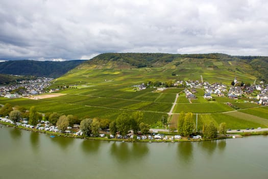 Aerial view of the Moselle valley with vineyards, the river Moselle and the villages Ellenz-Poltersdorf and Poltersdorf seen from castle Metternich in Beilstein, Rhineland-Palatinate, Germany.