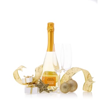 Bottle of muscat white young sparkling wine Chateau Tamagne 2018, gift boxes and Christmas ornaments isolated on a white background. New Year and Christmas