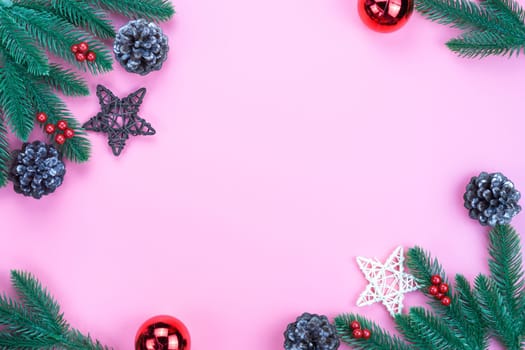 Christmas holidays composition, top view of red Christmas decorations on pink background with copy space for text. Flat lay, winter, postcard template, new year concept.