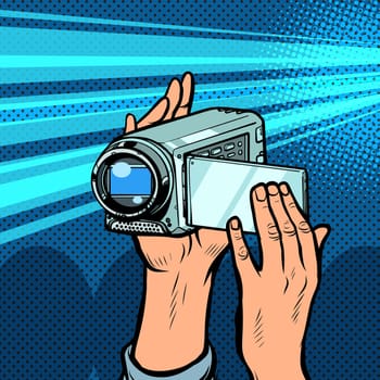 portable hand-held video camera. Pop art retro vector illustration kitsch vintage 50s 60s