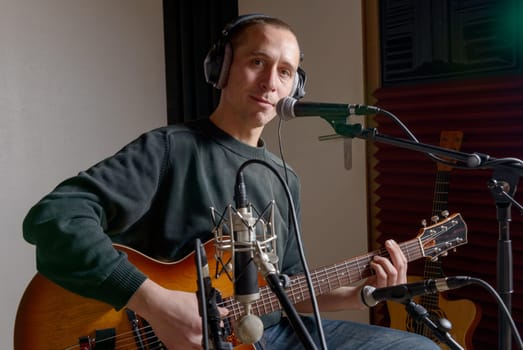 guitarist in a recording studio with headphones