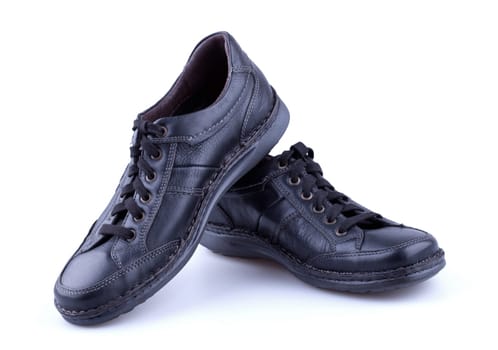 Black leather men’s shoes isolated on white background.
