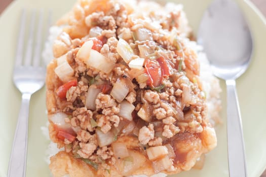 Fried pork with tomato sauce topping on fried egg, stock photo
