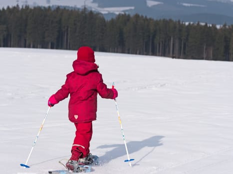 Child walks with snowshoes