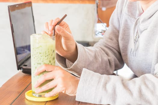 Glass of iced green tea latte, stock photo