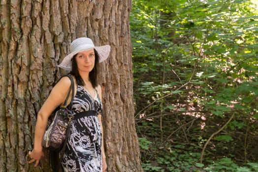 Actractive girl portrait in the forest with tree background