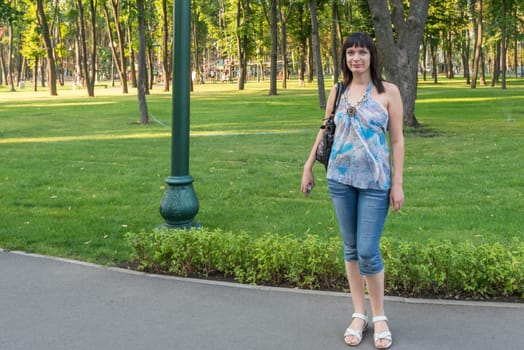 a portrait of a nice girl smiling in a park
