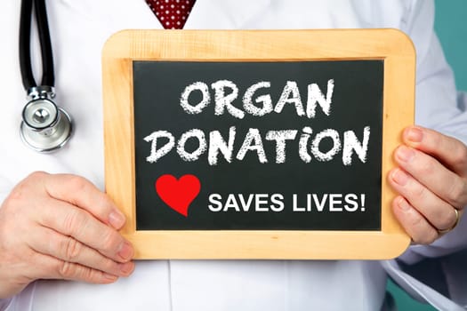 Doctor holding chalkboard - Organ Donation Saves Live!