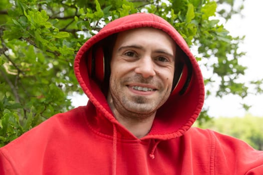 Young confident man wearing hoodie and headphone